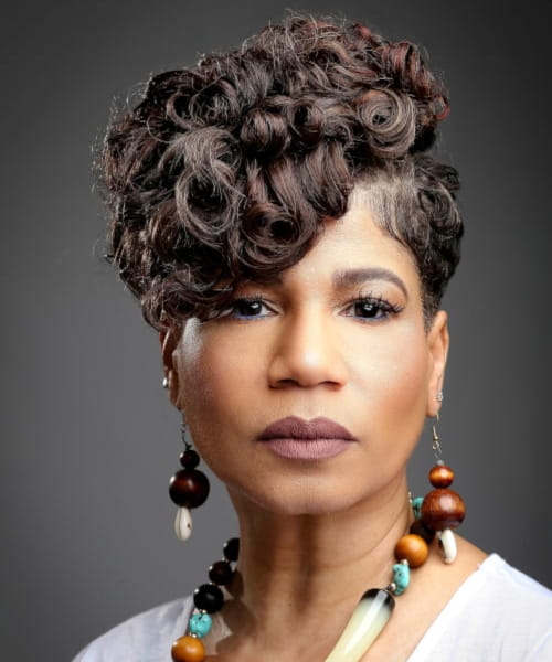 Precision haircut for curly hair.
Elegant mature woman rocking one of the low maintenance short natural haircuts for black females by the Beauty Lounge.